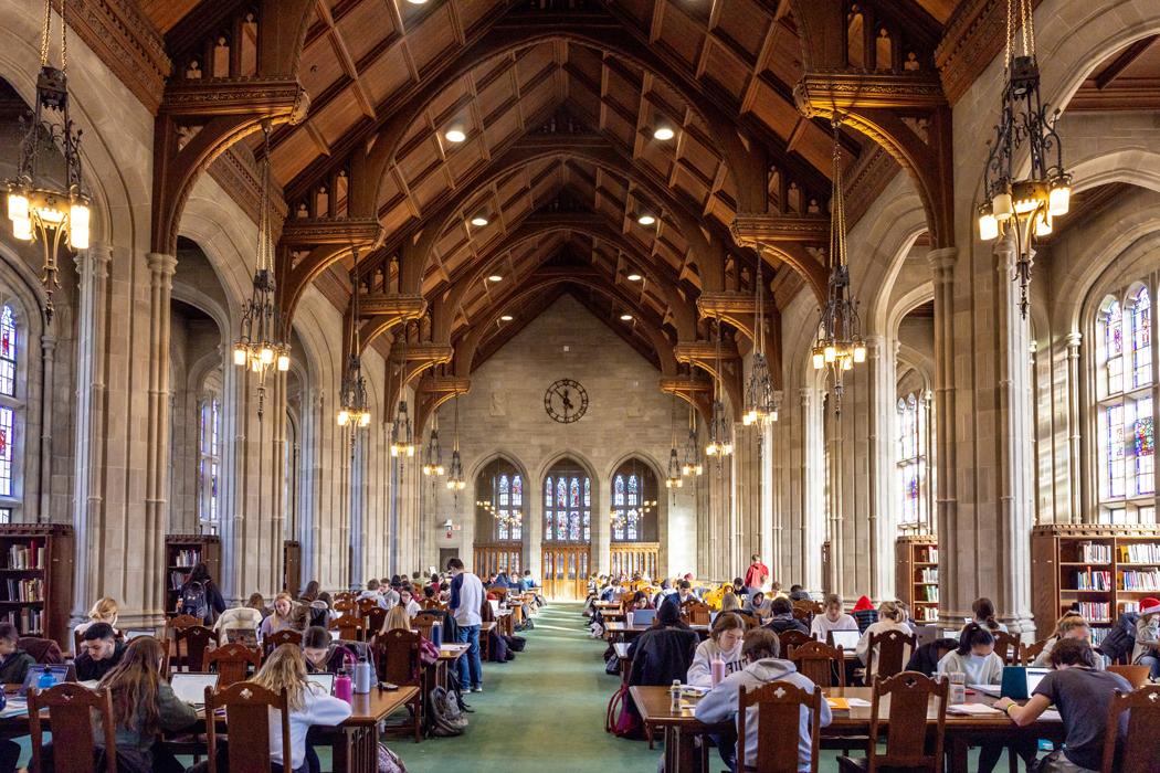 students studying in a collegiate gothic library